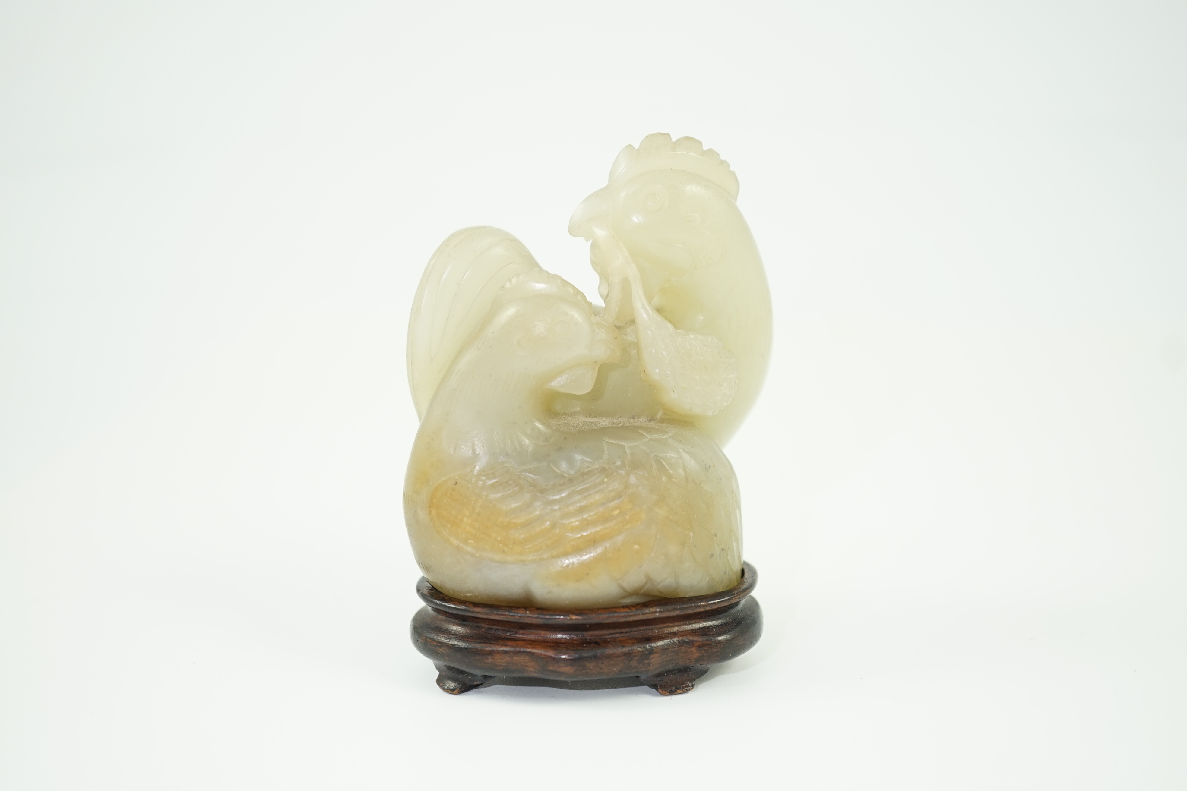 A Chinese pale celadon jade chicken group, 19th century, small faults